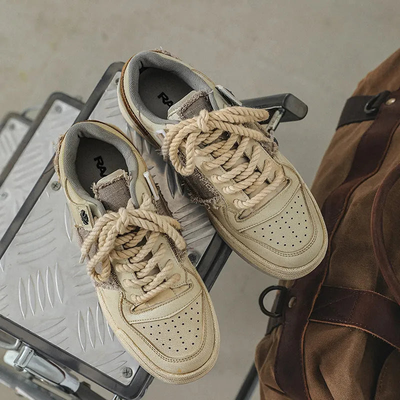 Beige vintage low-top skateboard shoes with round toe and lace-up front
