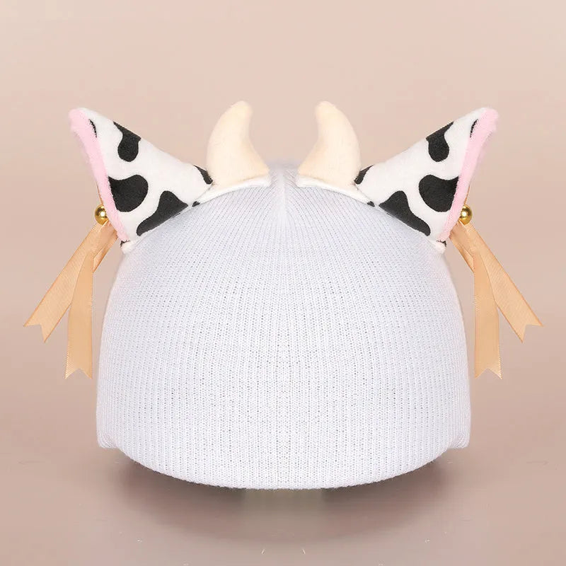 A plush fabric cartoon character helmet hat cover with attached ears on a white background.