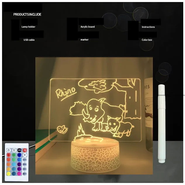 Black 3D acrylic message board night light on desk with remote control and stylus.