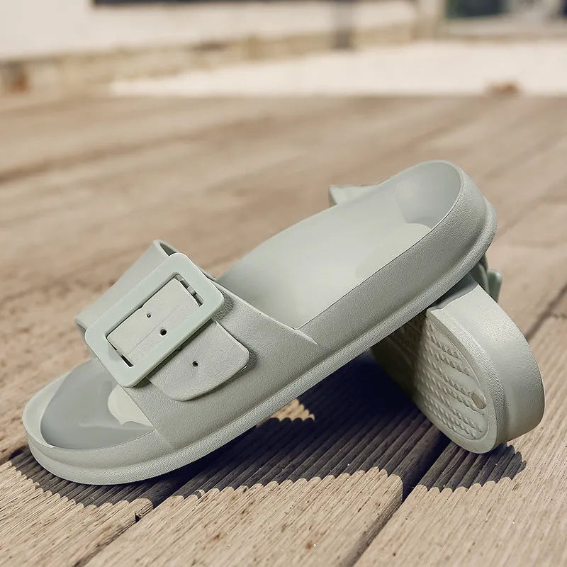Women's grey blue flip flop slippers with a buckle strap and soft EVA sole.