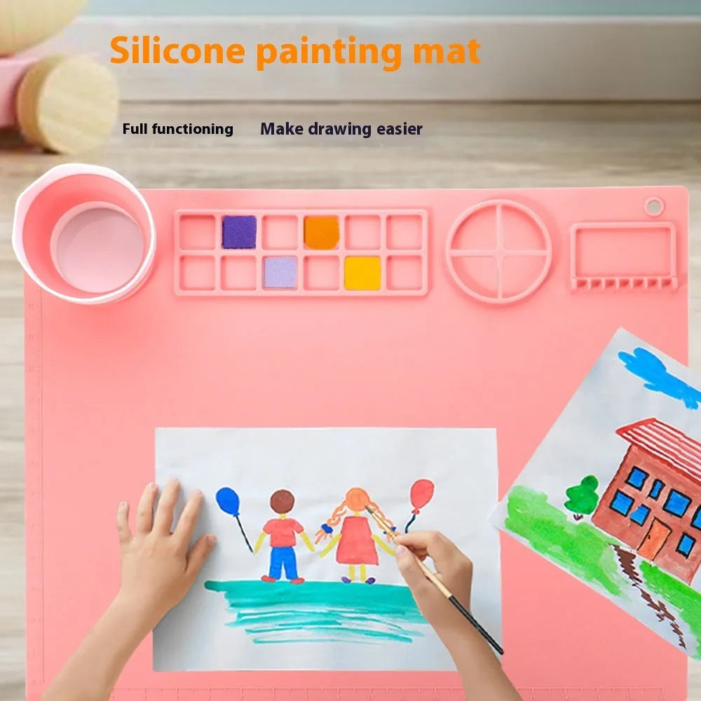 Green silicone painting mat measuring 50x40cm with two round paint mixing bowls on the surface.