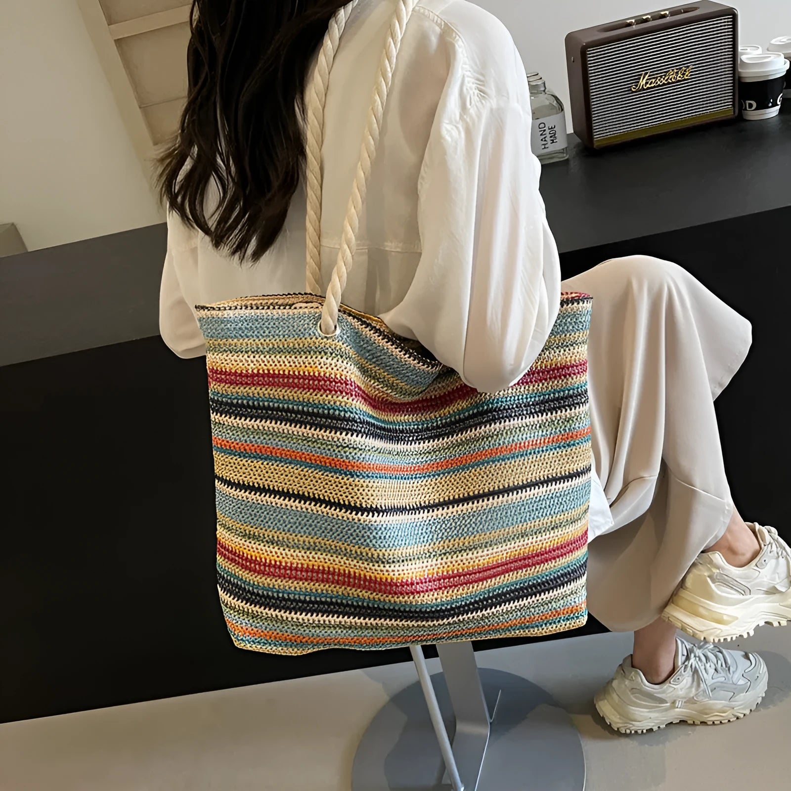Blue woven straw shoulder bag with traditional weaving patterns and single shoulder strap