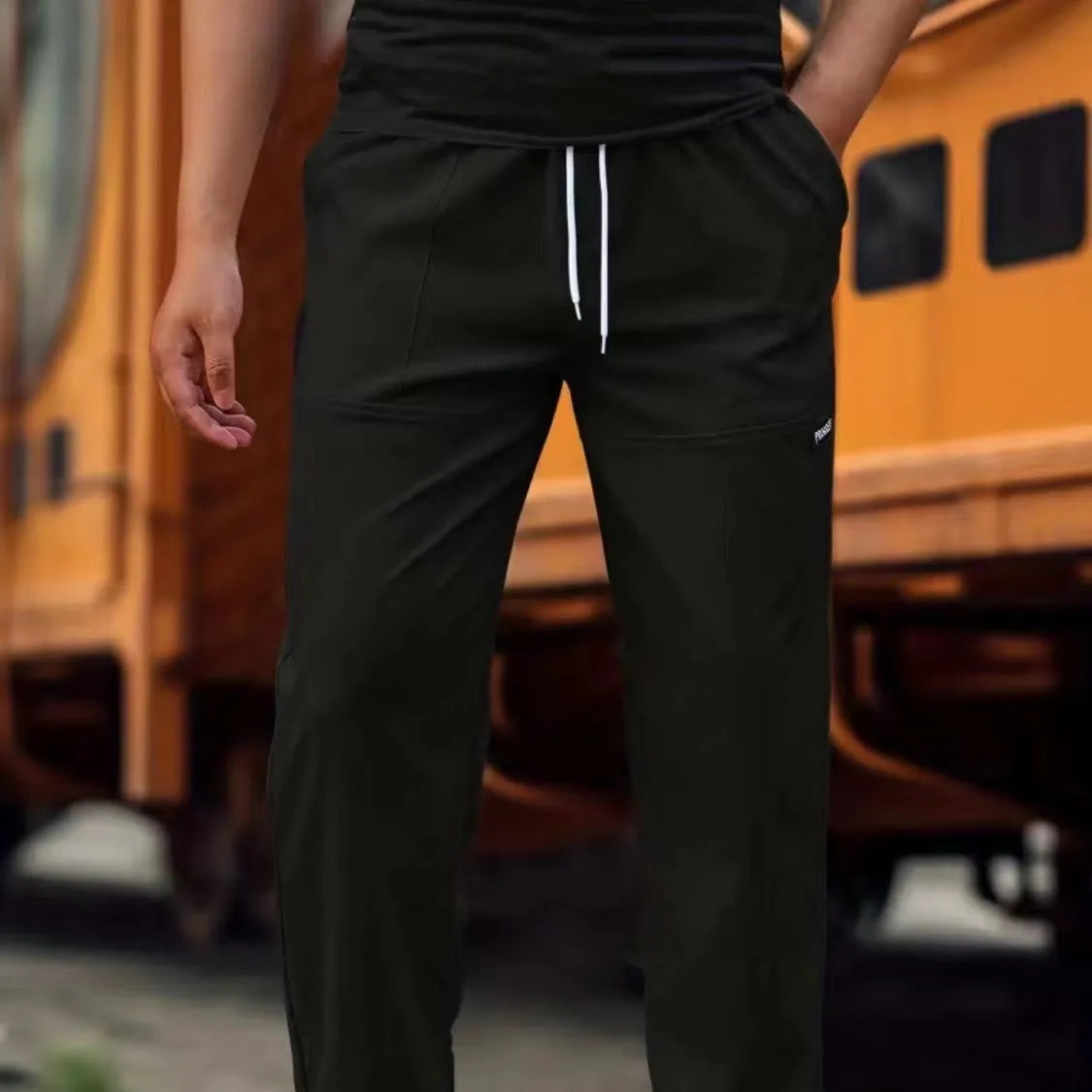 Men's lightweight polyester casual trousers in light grey colour shown flat