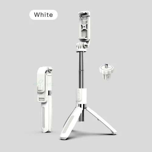 Black and white Bluetooth selfie stick with wireless remote, extended on a tripod base next to a smartphone.