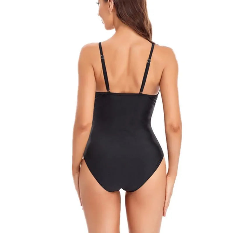 A black solid colour backless one-piece ladies swimsuit on a model.