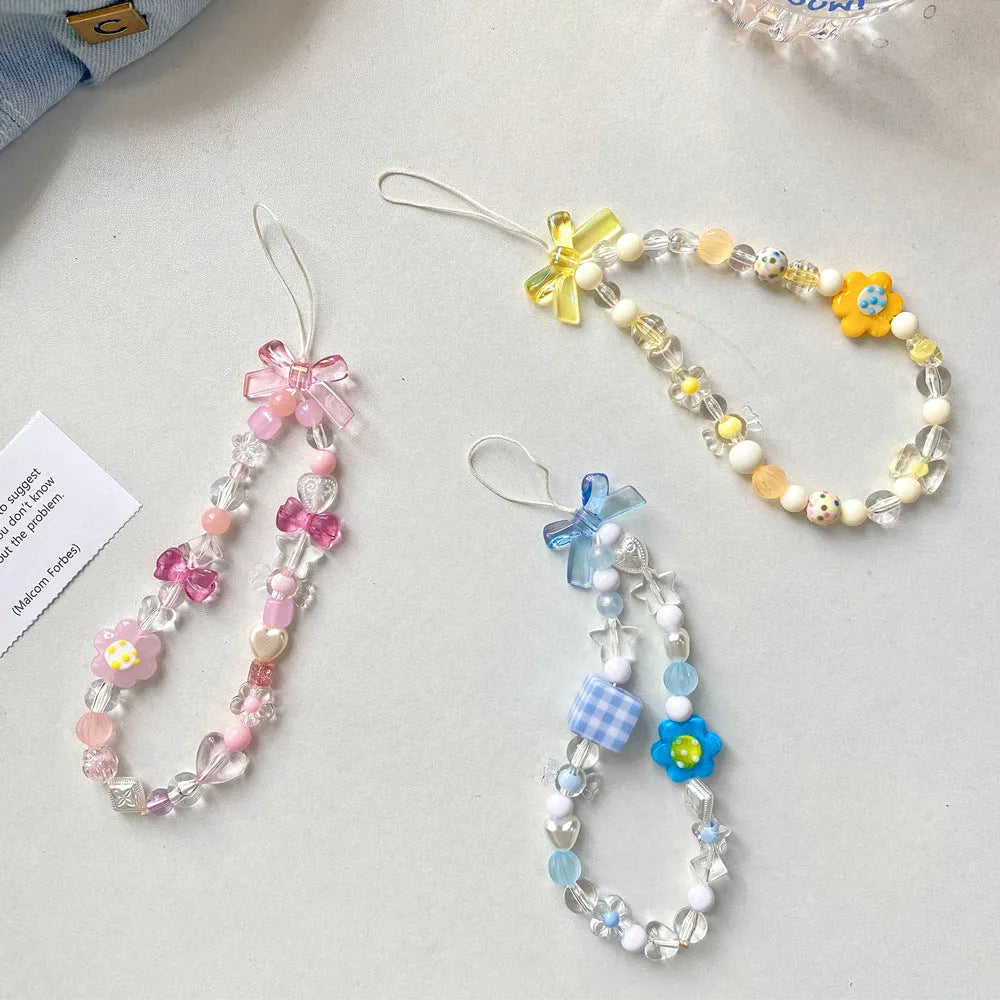 Beaded flower mobile phone lanyard with floral designs in yellow, blue, and pink colour options