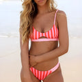 Women's bikini swimsuit in black and white dot pattern and red and white stripe option.
