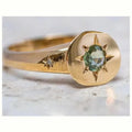 Gold-coloured adjustable ring with a star-shaped asterism zircon stone on a zinc alloy band.
