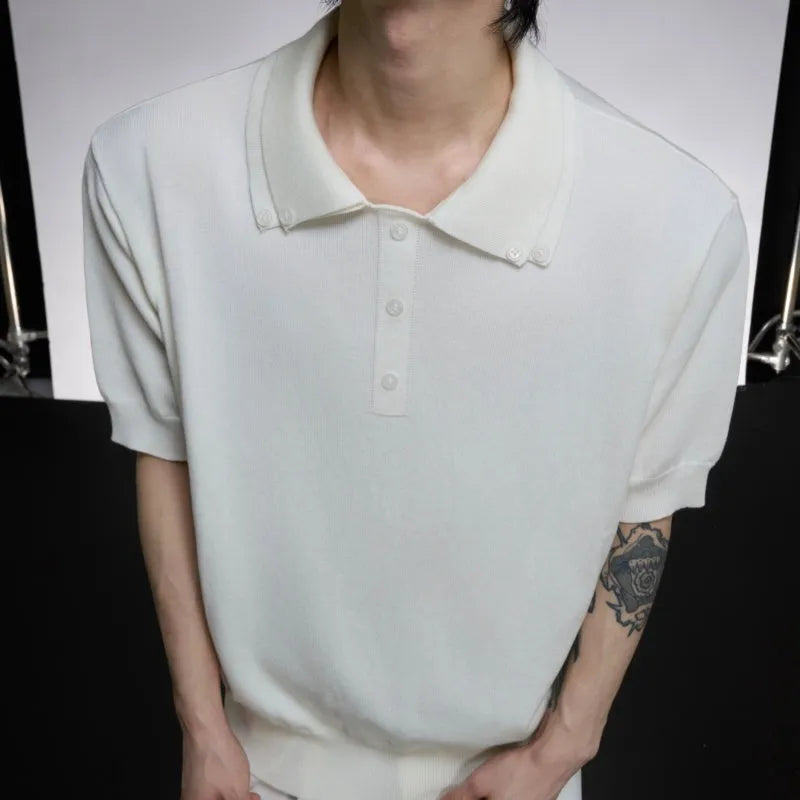 Man wearing a grey loose fit short sleeve shirt with a double collar lapel design.