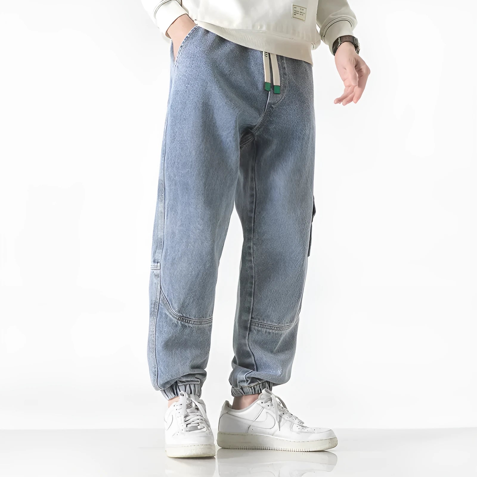 Men's loose-fit tapered cotton trousers in black colour showing mid-waist design and tapered leg cut