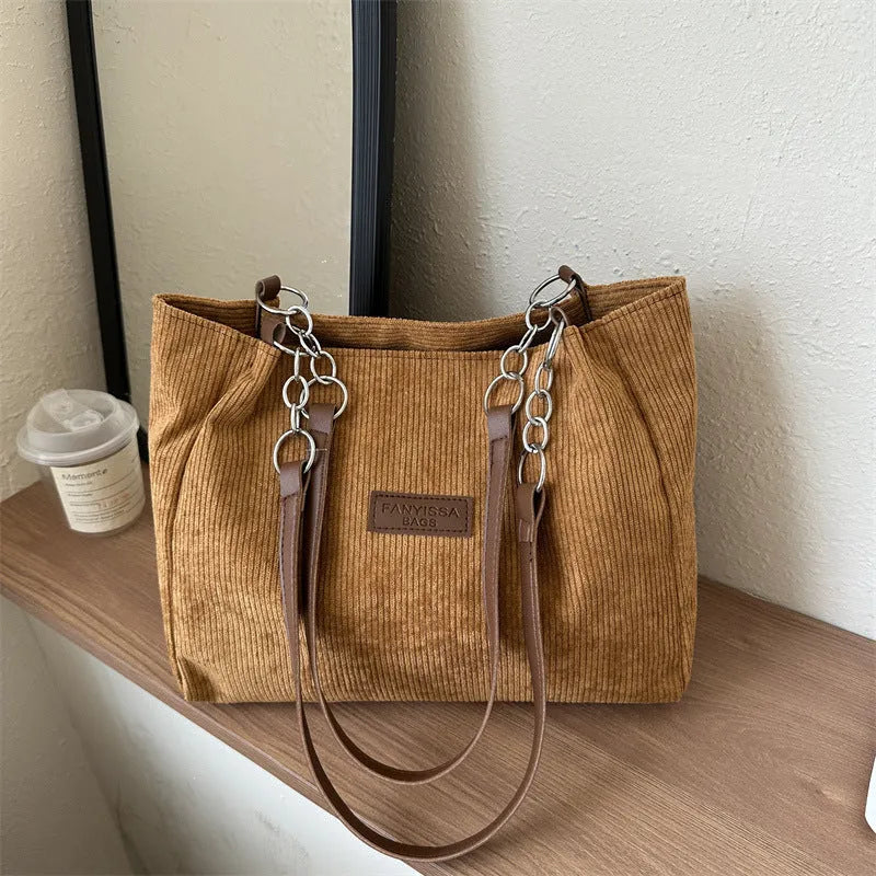 Corduroy one-shoulder tote handbag in a horizontal square shape, shown in brown colour.