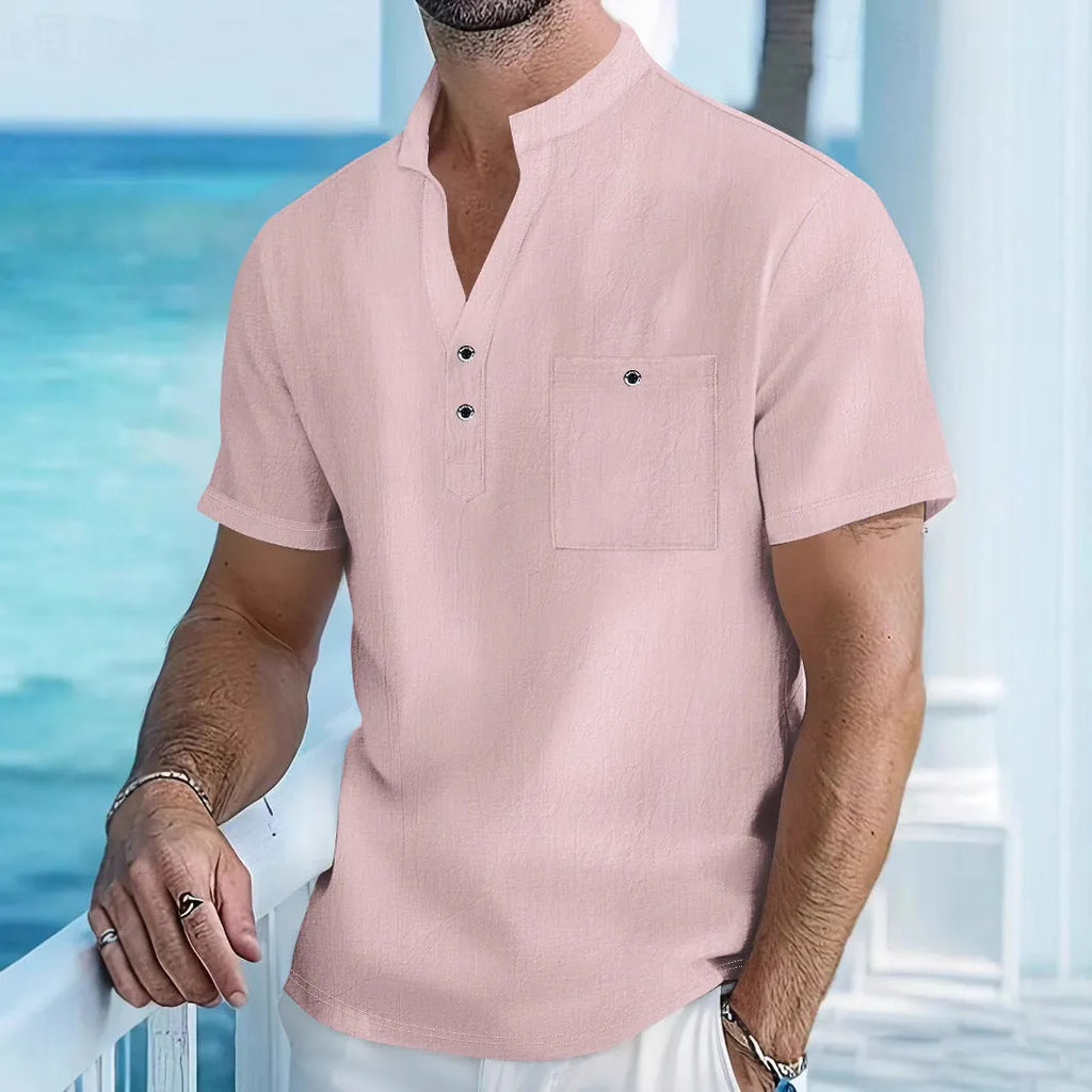 Man wearing a light-coloured linen stand collar short sleeve t-shirt in a relaxed fit.