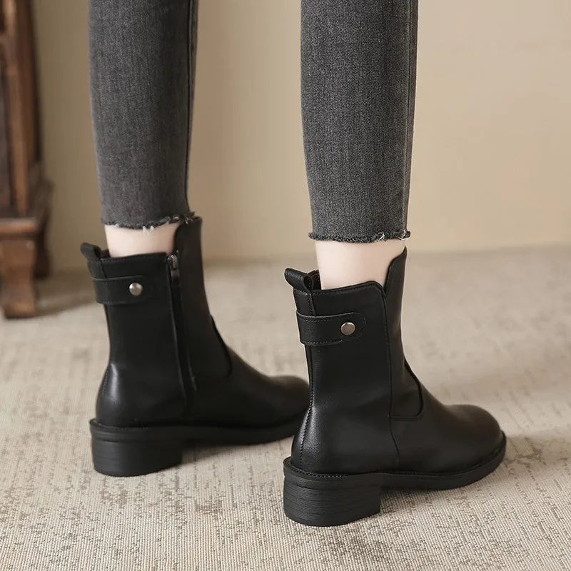Black women's ankle boots with side zip and a low round toe.