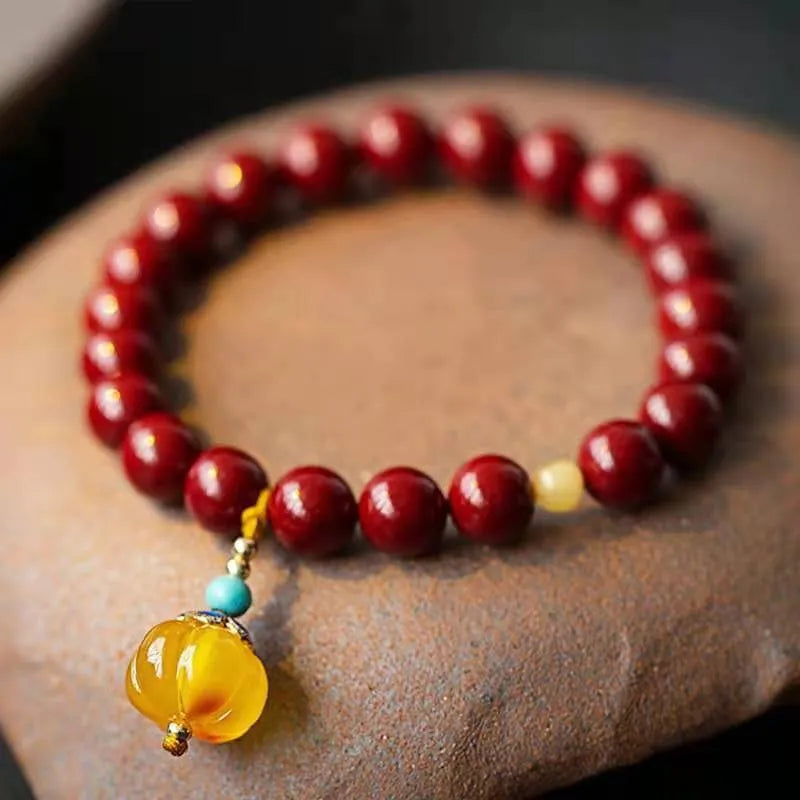 Handmade wave-shaped bracelet with alternating cinnabar and copper beads.