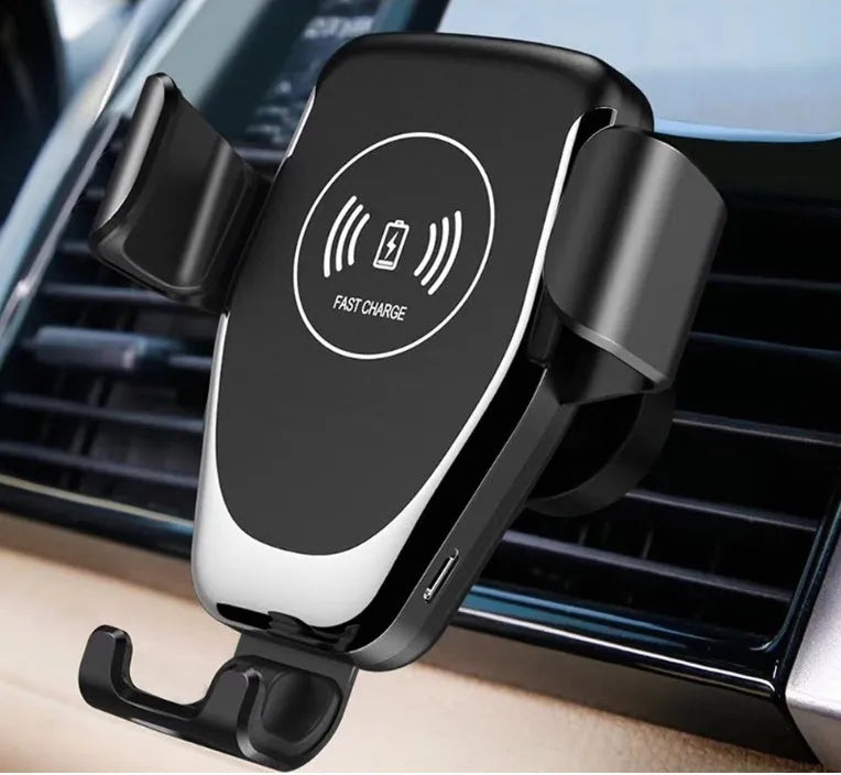 Black wireless car charger with phone clamped, mounted on a car ventilation vent.