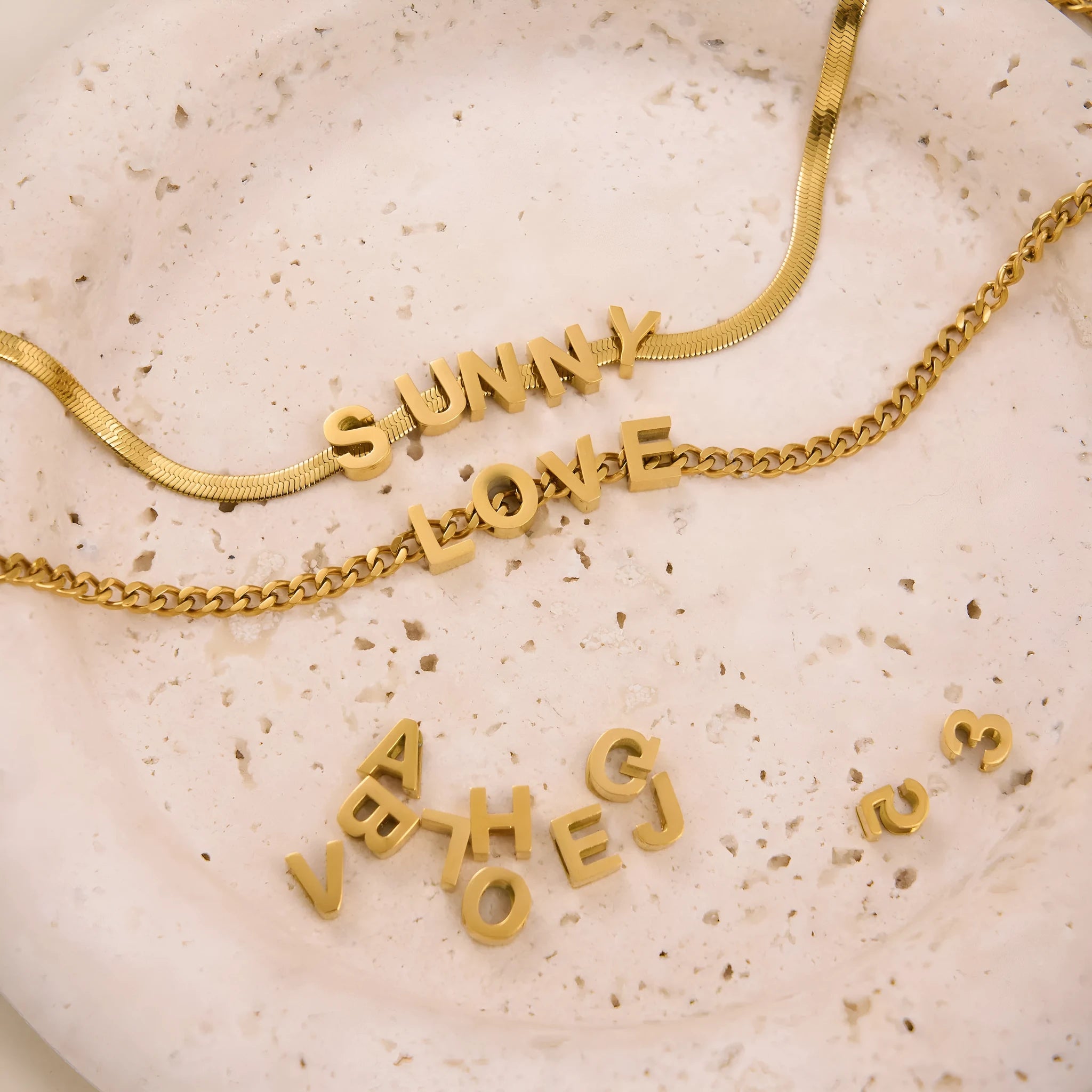 Gold titanium steel necklace with a letter A charm on a 40.5cm chain.