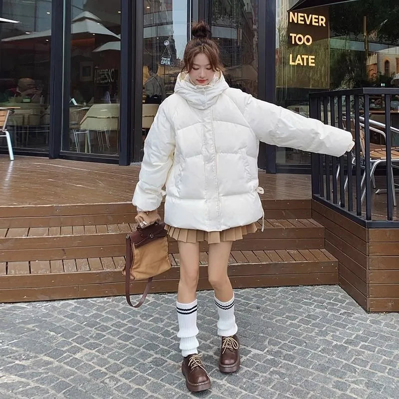 Women's loose black padded winter jacket with princess sleeves on a hanger.