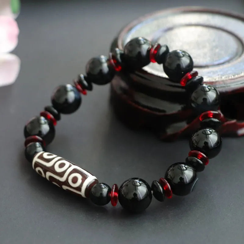Black agate Dzi bead bracelet with geometric 11mm beads on wrist