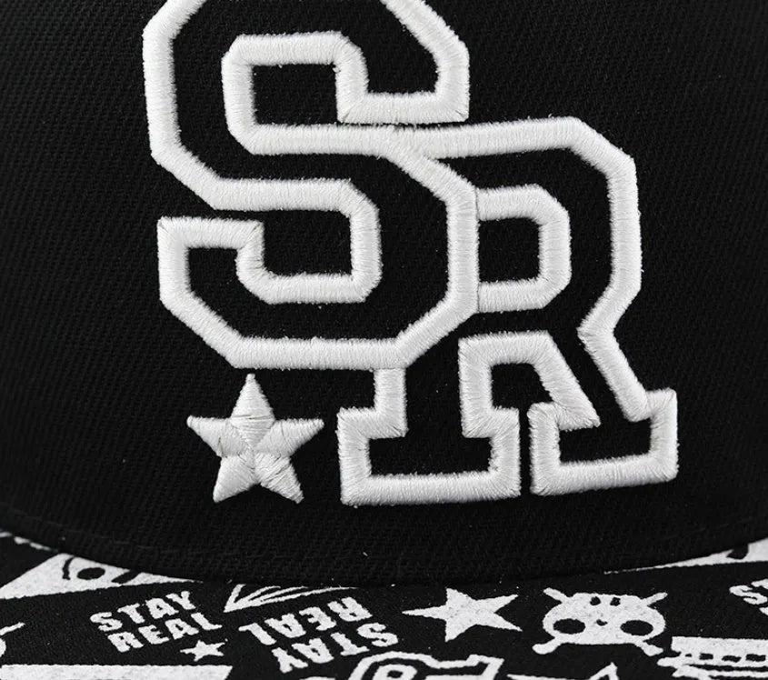 Cotton baseball cap with embroidered letters in black or white, showing adjustable strap.