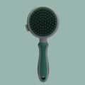Green and pink 2-in-1 silicone pet grooming brush showing slicker brush side and massage side