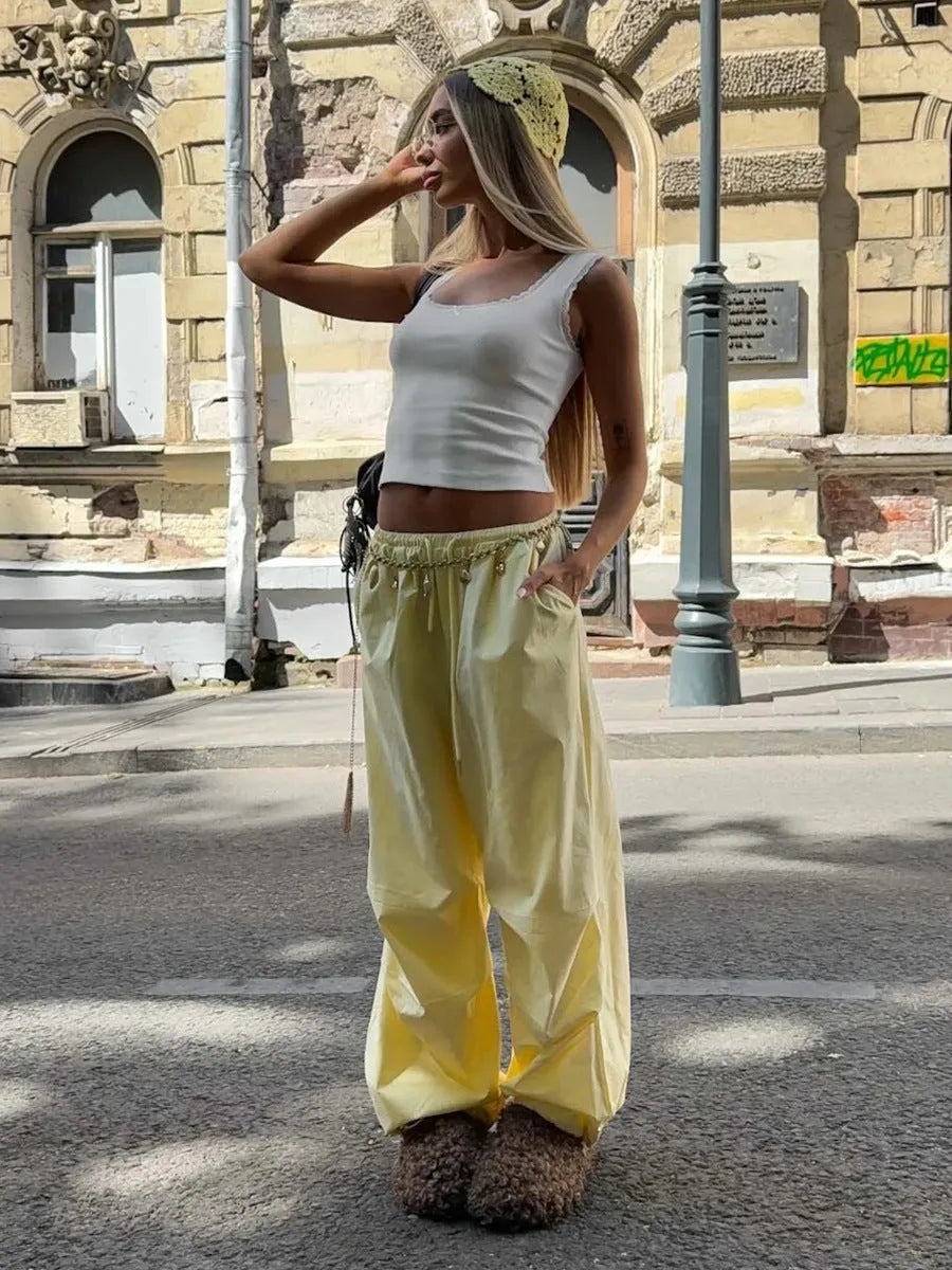 Women's polyester drawstring loose casual trousers in solid yellow colour on model