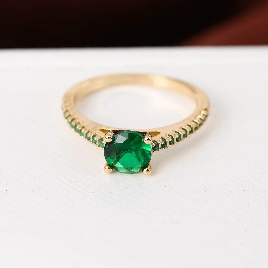 Hexagon geometric zircon ring on a finger, showing electroplated gold rose red colour and copper band.