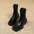 Black women's platform Martin boots with a square toe, high heel, and back zip.