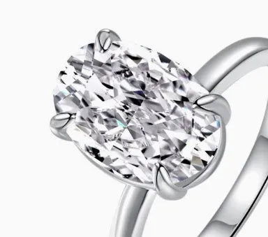Oval 9 silver women's ring with four-claw setting holding a hand-cut gemstone.