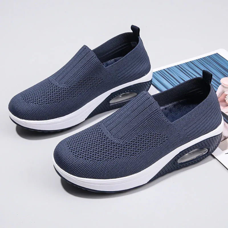 Women's mesh running shoes in beige with round toe and air cushion midsole.