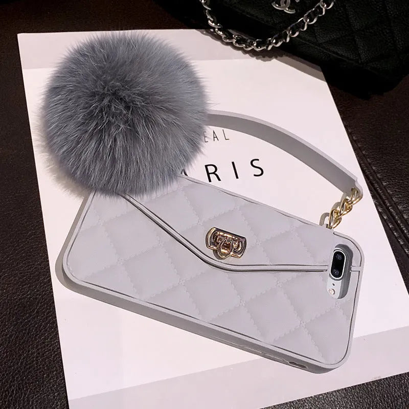 Soft plush hairball phone case for iPhone in dark green grid pattern.