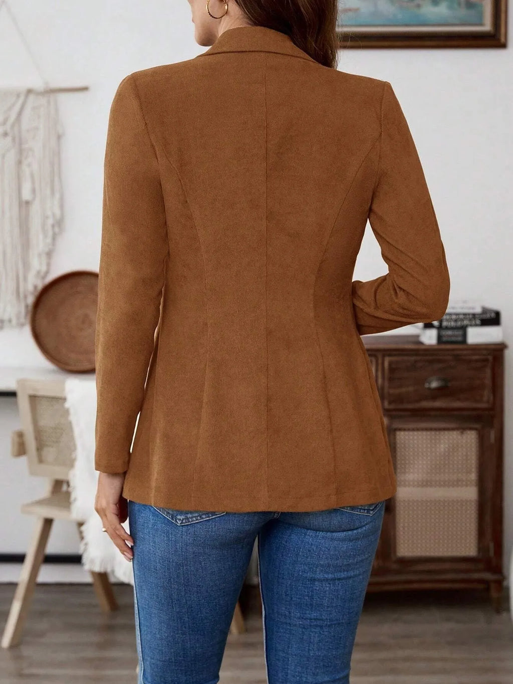 Brown men's single-breasted leisure suit coat with lapel collar on a hanger.