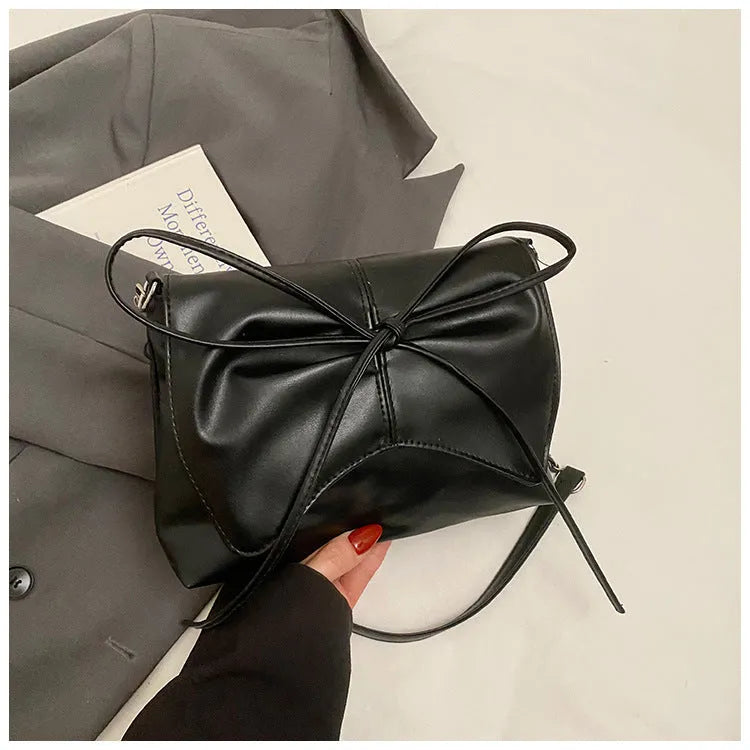 Women's underarm crossbody bag in horizontal square shape with sewing line details and phone pocket