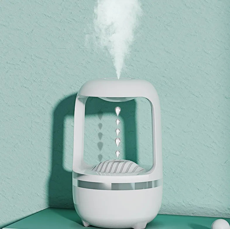Black anti-gravity humidifier showing water droplet backflow effect with USB cable