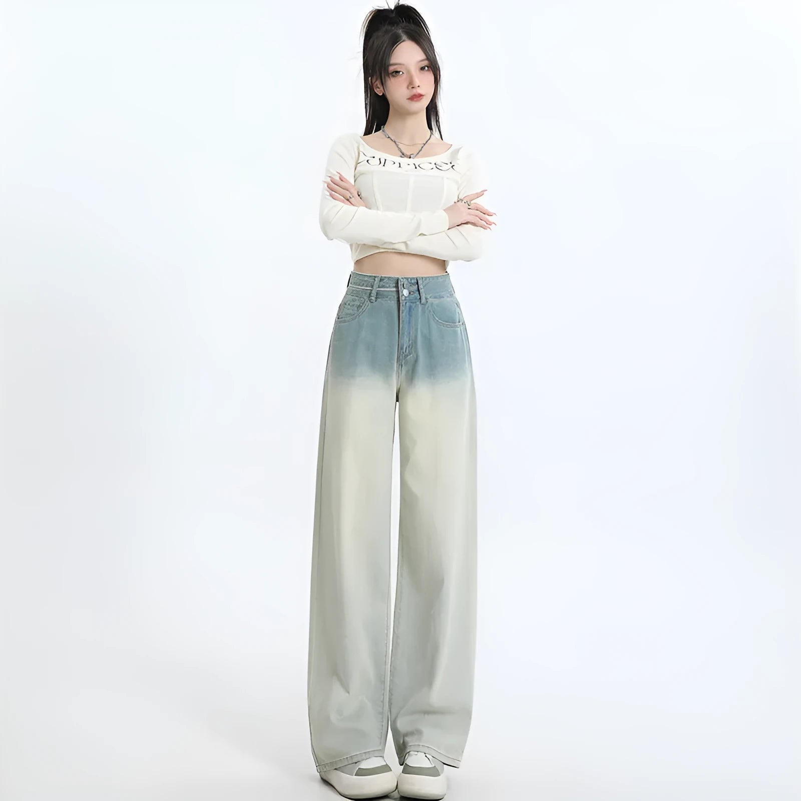 Women's gradient blue straight-leg denim trousers on a model, showing the ombré colour effect.
