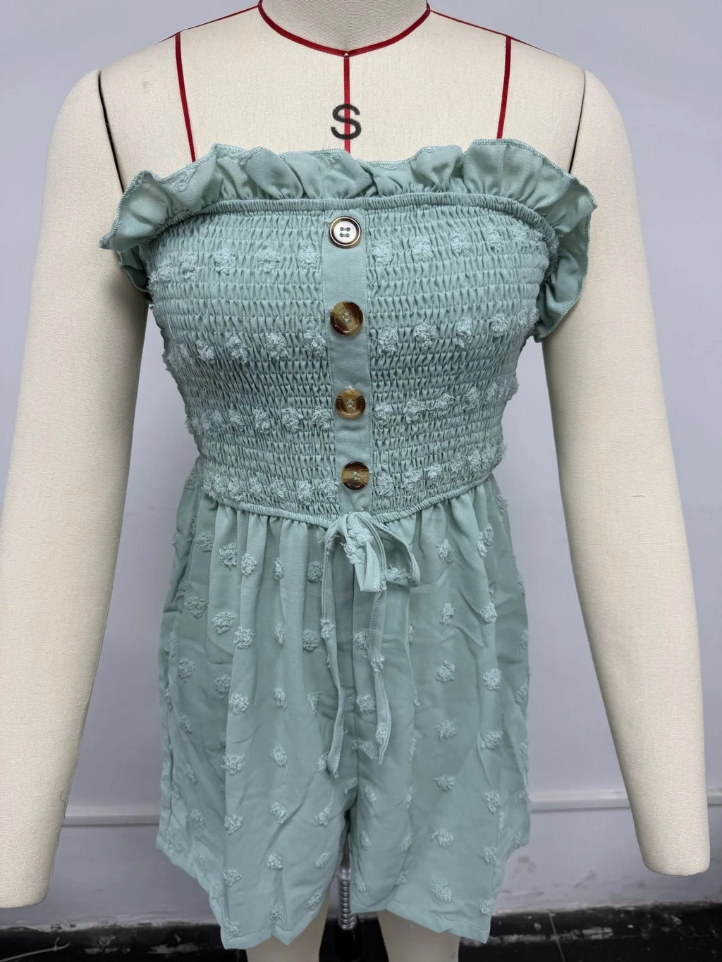 Women's blue off-the-shoulder jumpsuit with sleeveless design and button details