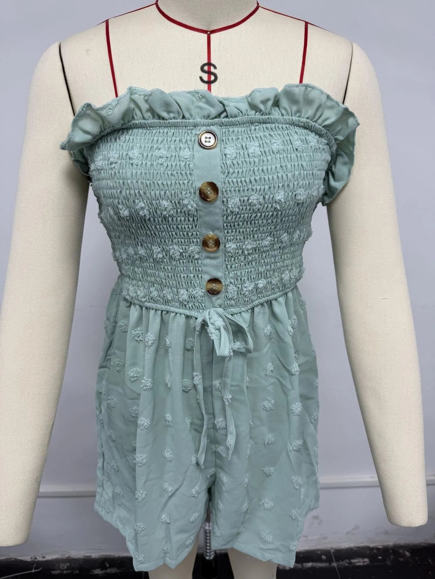 Women's blue off-the-shoulder jumpsuit with sleeveless design and button details