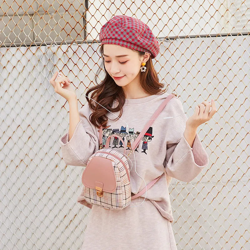 Diagonal shoulder phone bag in PU material showing adjustable strap and handheld carry option