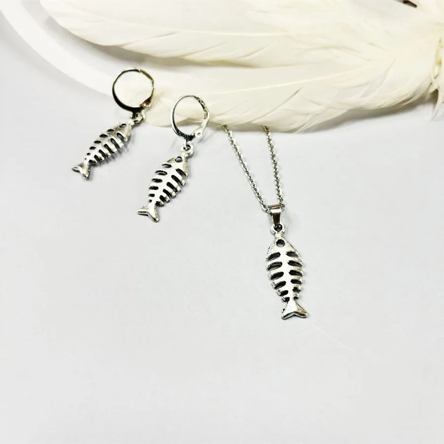 Fishbone pendant necklace and earrings set with adjustable chain on white background