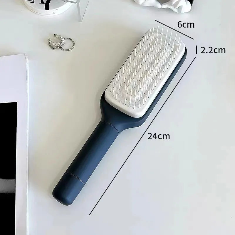 Self-cleaning hair brush with rotating handle, anti-static teeth and scalp massage points in purple and grey colours