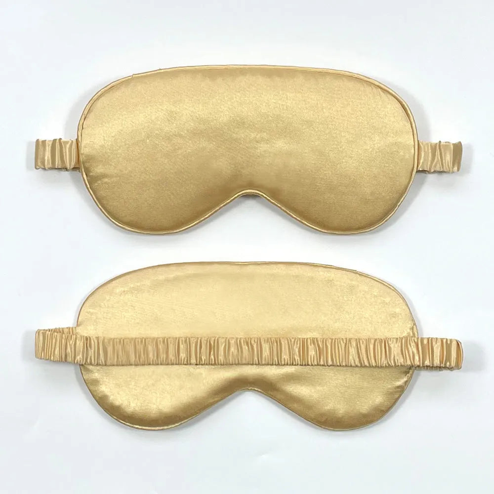 Reversible silk-like sleep eyeshade shown in multiple colour options including sky blue, wine red, and black.