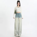 Women's gradient blue straight-leg denim trousers on a model, showing the ombré colour effect.