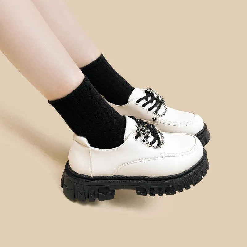 Women's Duke Asterism loafers with preppy style, round toe, and cross strap with metal detail.