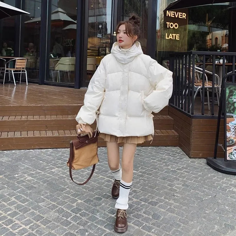 Women's loose black padded winter jacket with princess sleeves on a hanger.