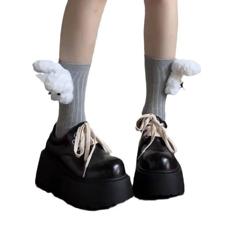 Women's matte black lace-up ankle boots with a thick rubber sole and a chunky heel on a white background.