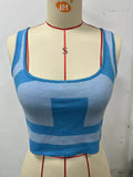 Women's slim fit U-neck camisole in grass green with a midriff cut-out detail.