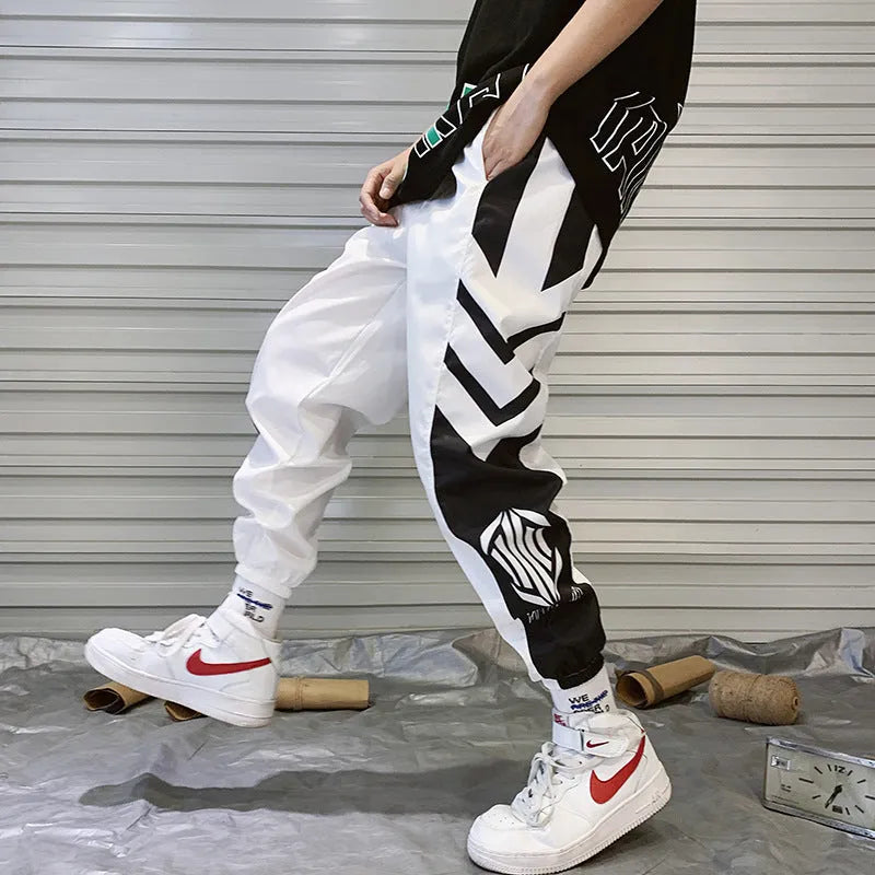 Men's hiphop trousers in black acetate fibre with tapered leg, side view