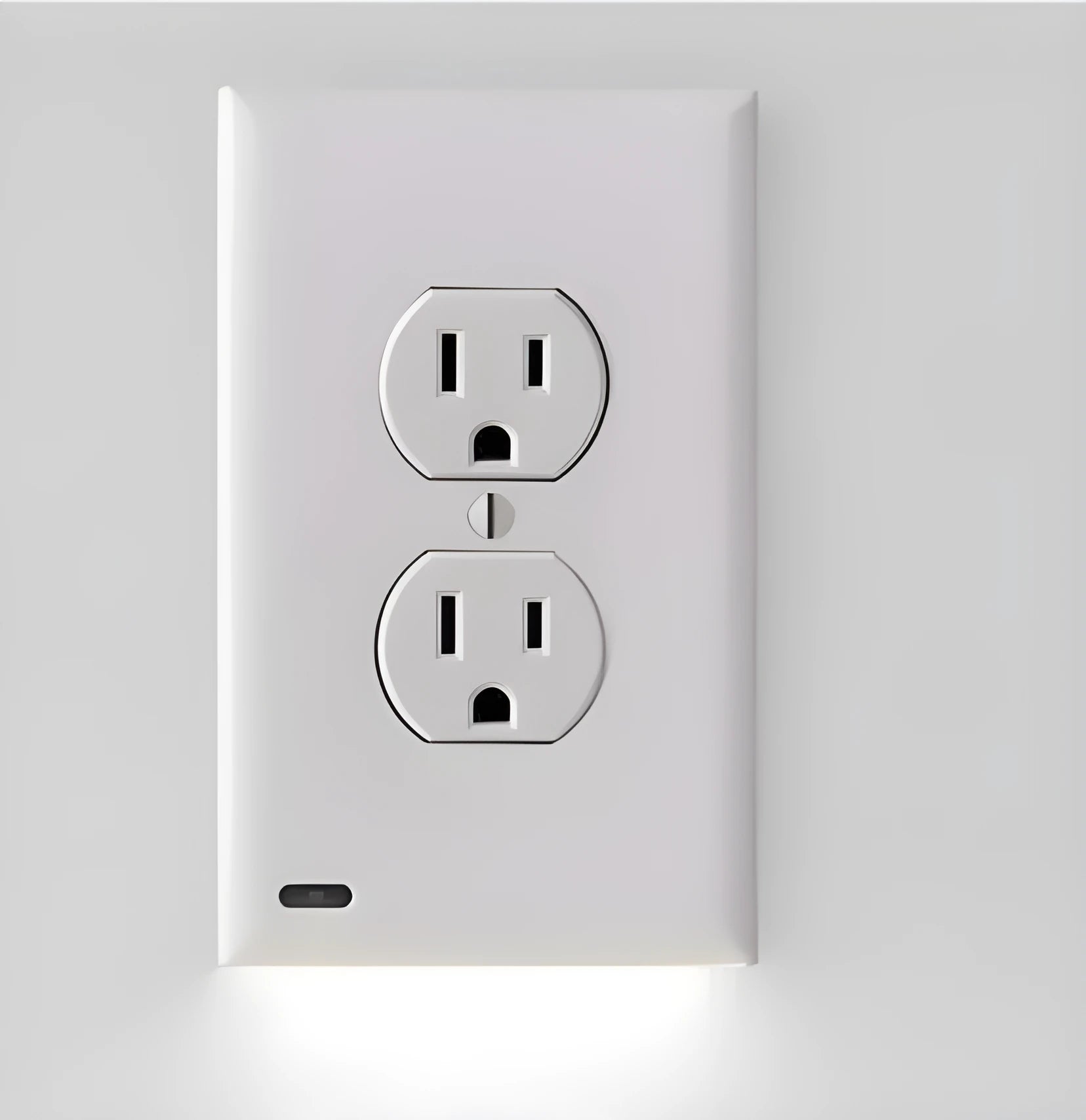 White socket induction LED night light plugged into wall outlet with automatic sensor