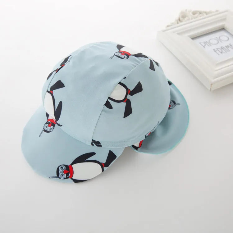 Boys' penguin pattern swimsuit set with long sleeves and matching swimming cap