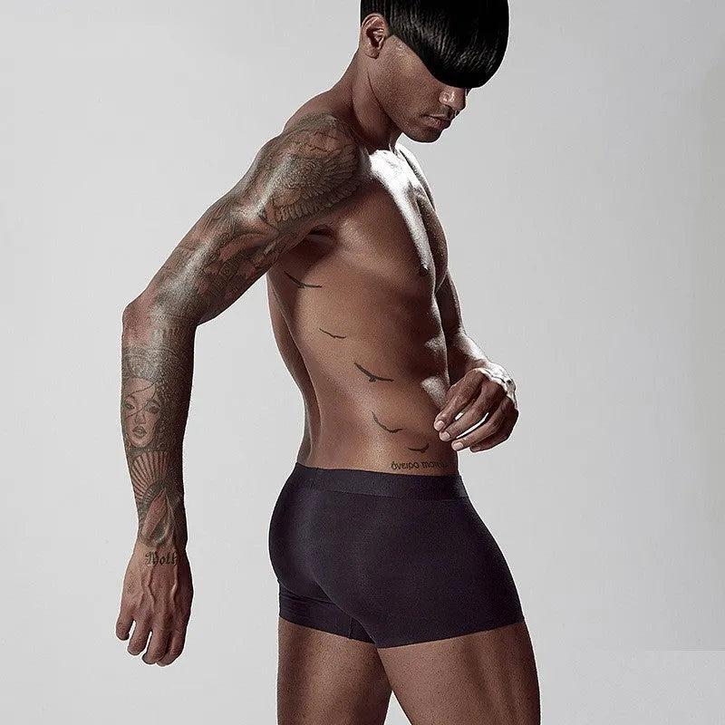 Men's seamless one-piece modal underwear in green, showing mid-waist fit and solid colour design.