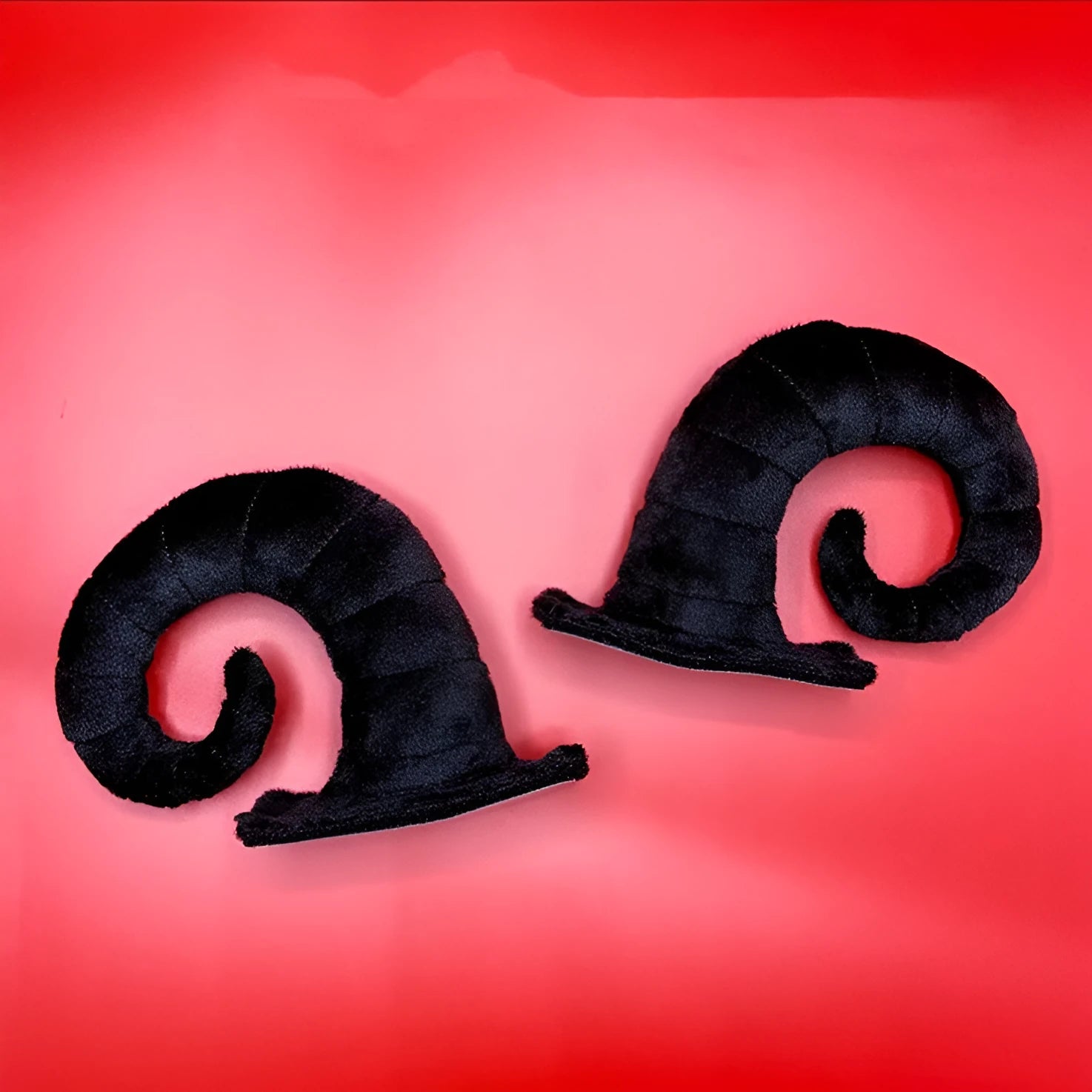 A pair of composite fibre demon horn decorations for a motorcycle helmet in black, pink, brown, or grey.